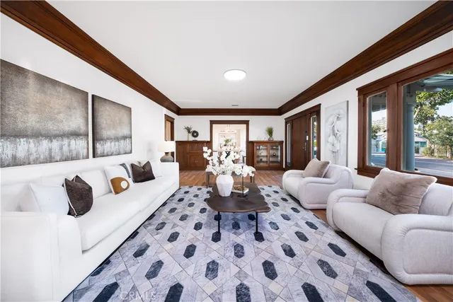 a living room with furniture fireplace and large window