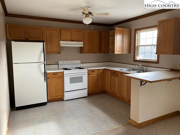a kitchen with a stove sink and refrigerator