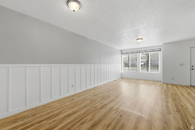 977 East 100 South Payson, UT 84651 - Photo 7 of 19 Spare room with light wood-style flooring and wainscoting