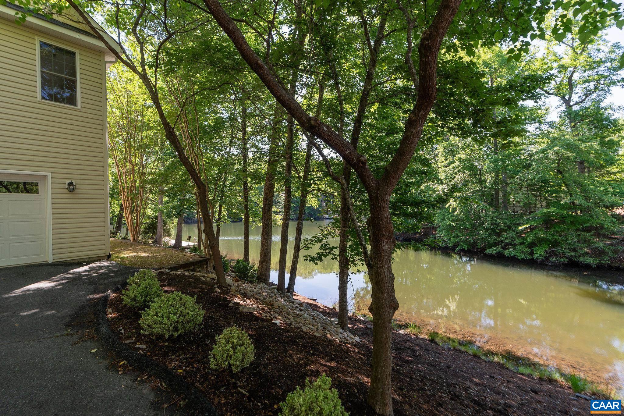 21 Amethyst Road Palmyra, VA 22963 - Photo 62 of 66 a view of a backyard with plants and large trees