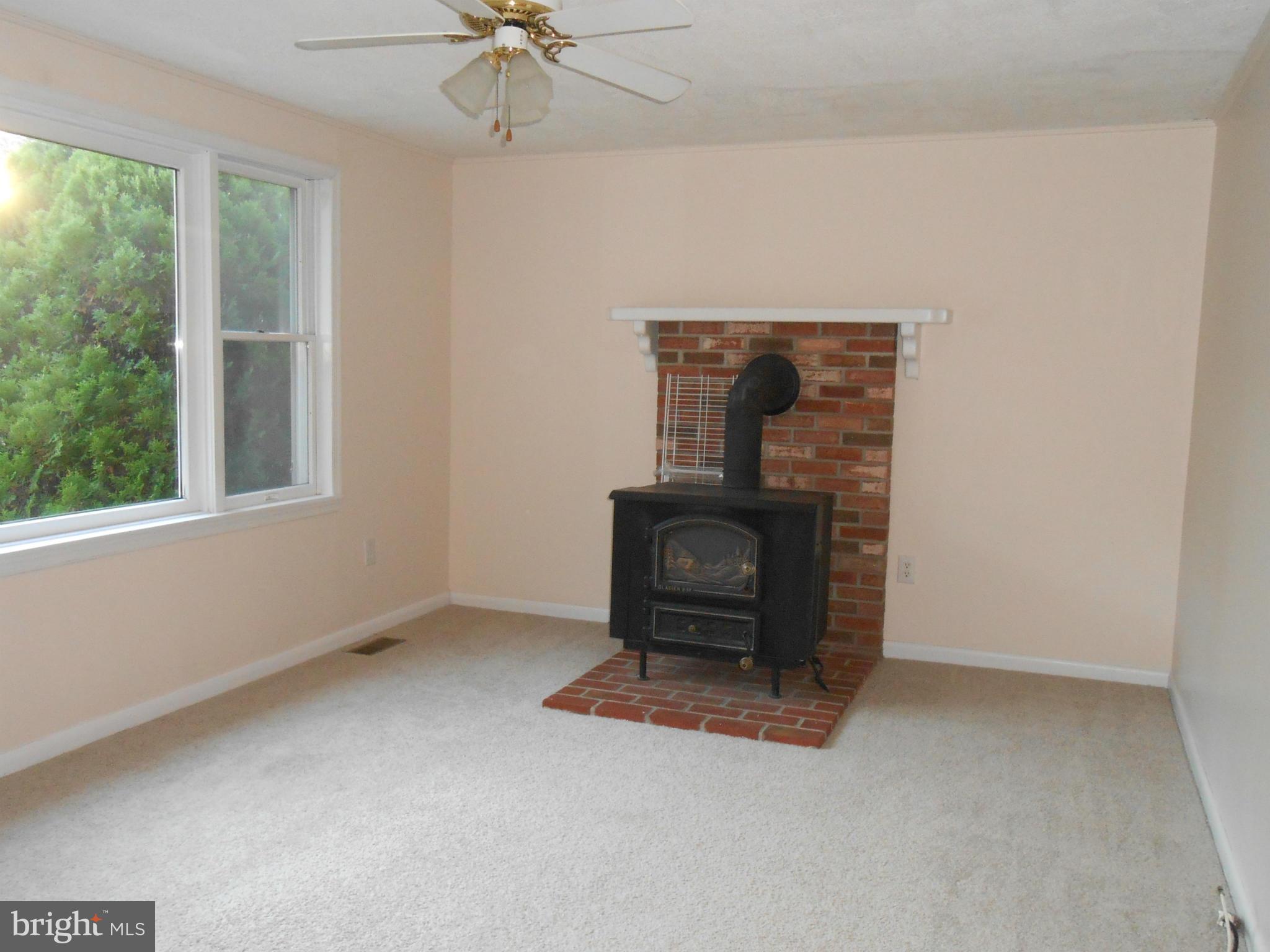 18111 Three Notch Road Lexington Park, MD 20653 - Photo 2 of 23 an empty room with a fireplace and windows