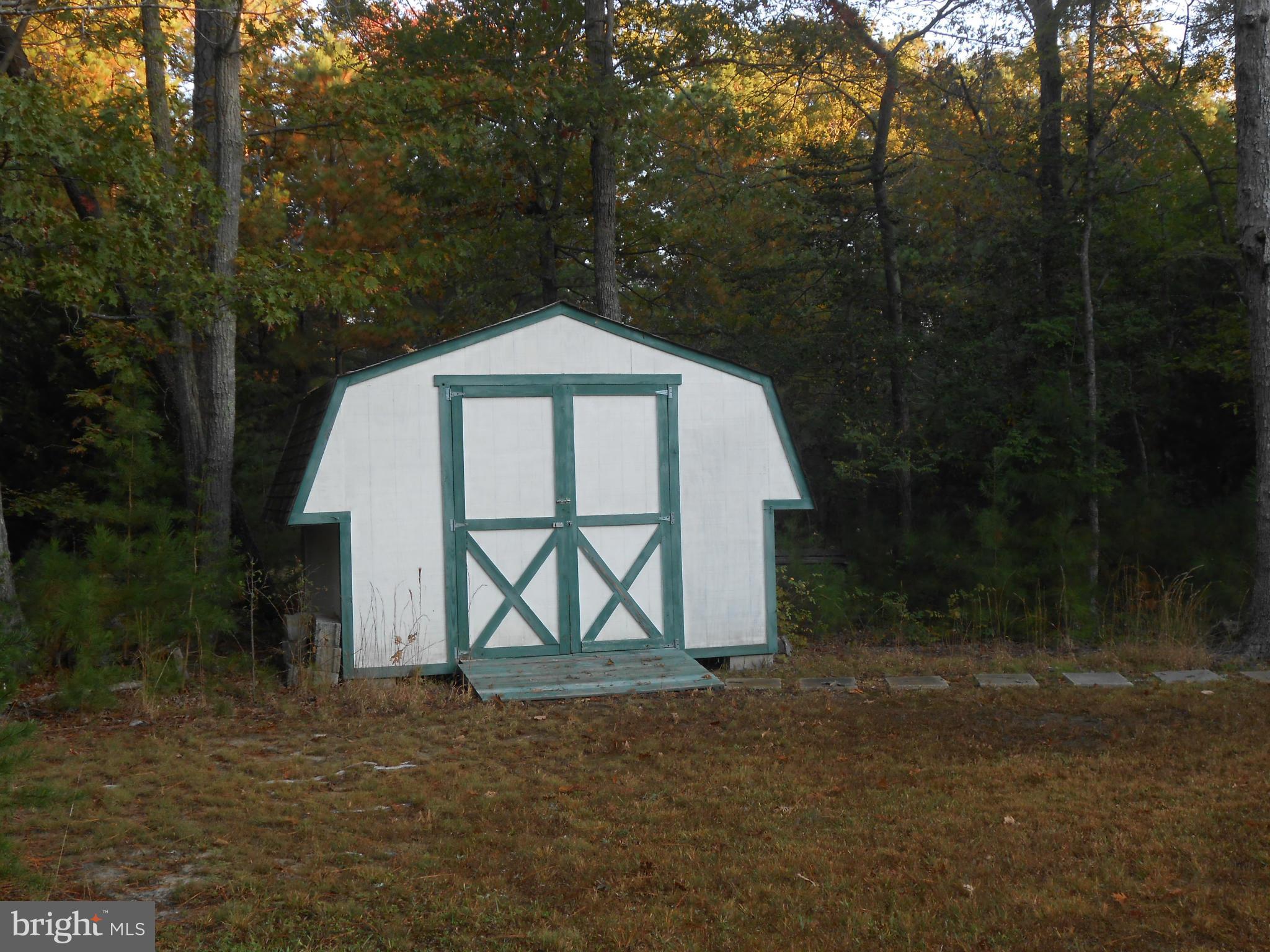 18111 Three Notch Road Lexington Park, MD 20653 - Photo 17 of 23 a view of a wooden house with a yard and large trees
