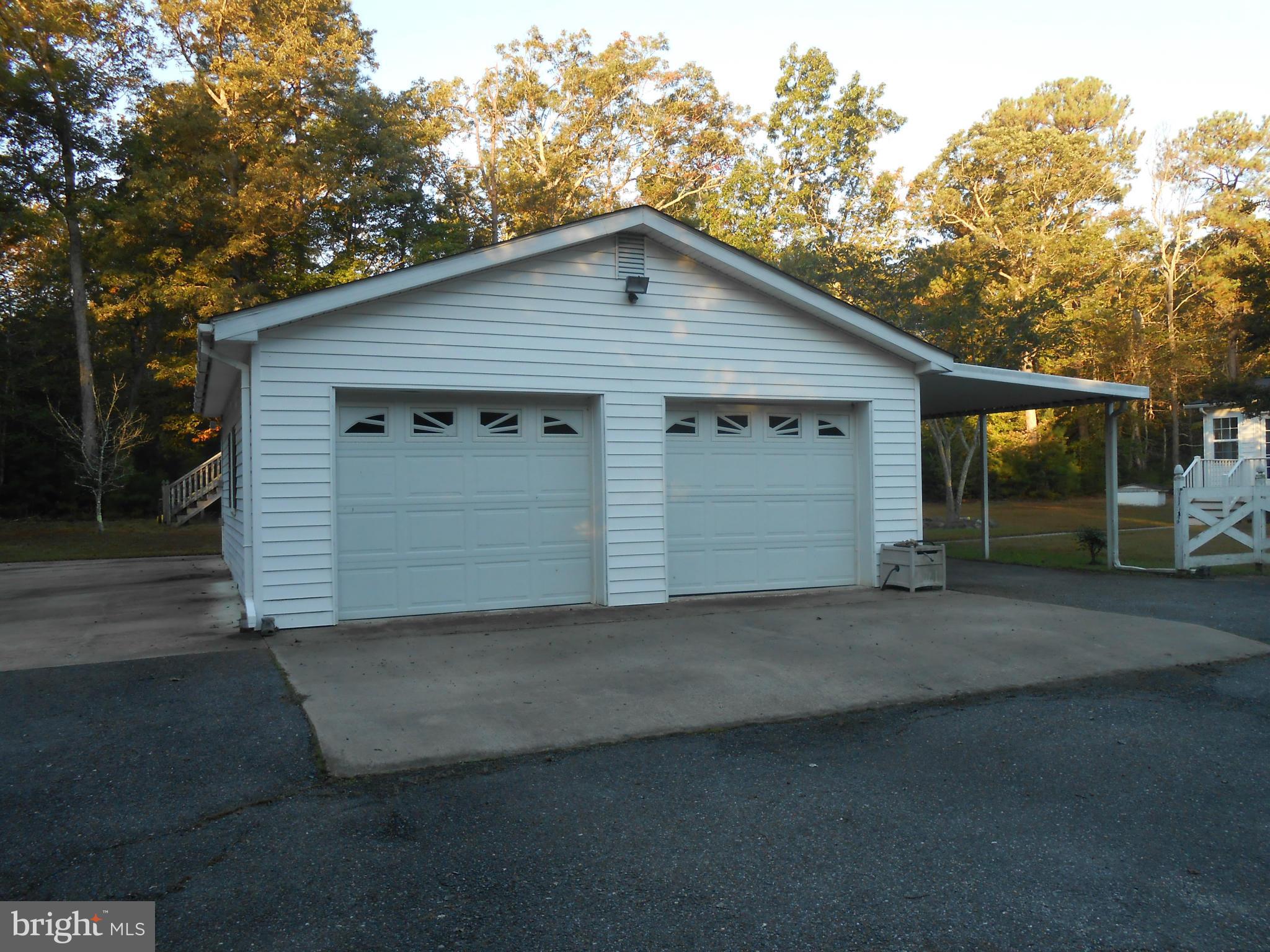 18111 Three Notch Road Lexington Park, MD 20653 - Photo 20 of 23 a front view of a house with a yard and garage