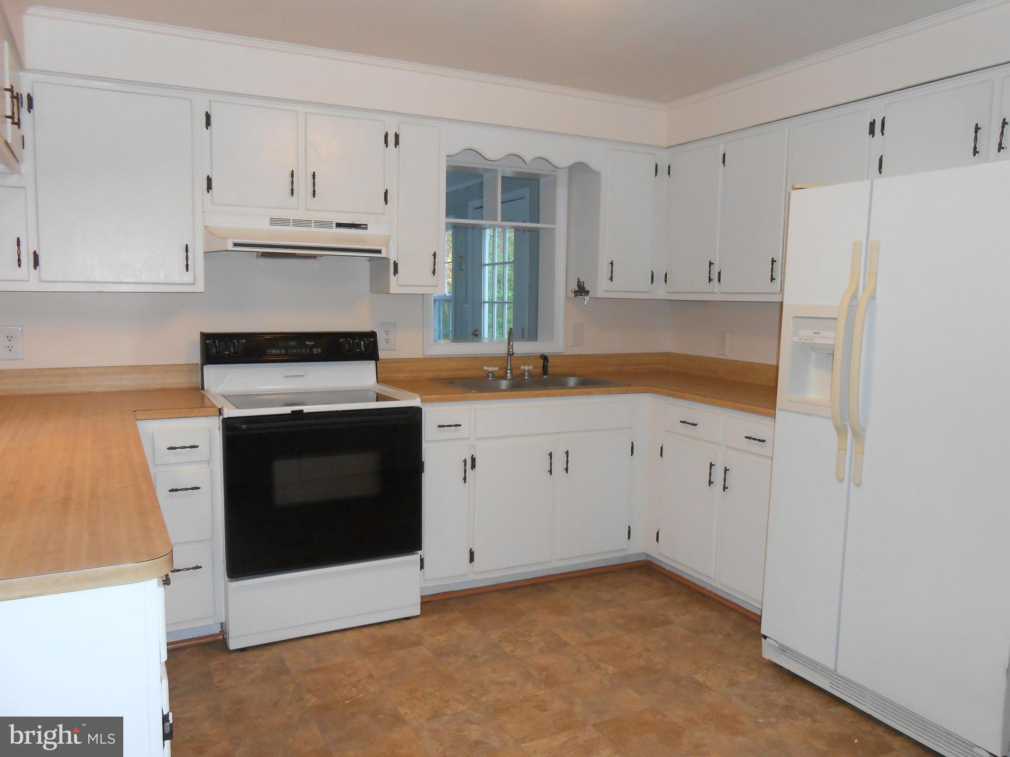 18111 Three Notch Road Lexington Park, MD 20653 - Photo 3 of 23 a kitchen with granite countertop white cabinets and refrigerator