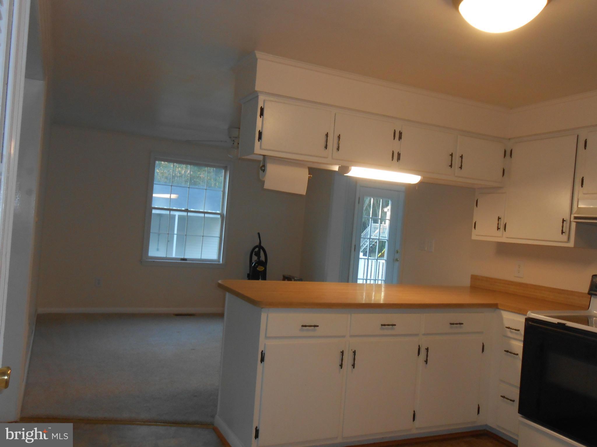 18111 Three Notch Road Lexington Park, MD 20653 - Photo 4 of 23 a kitchen with granite countertop white cabinets and a sink