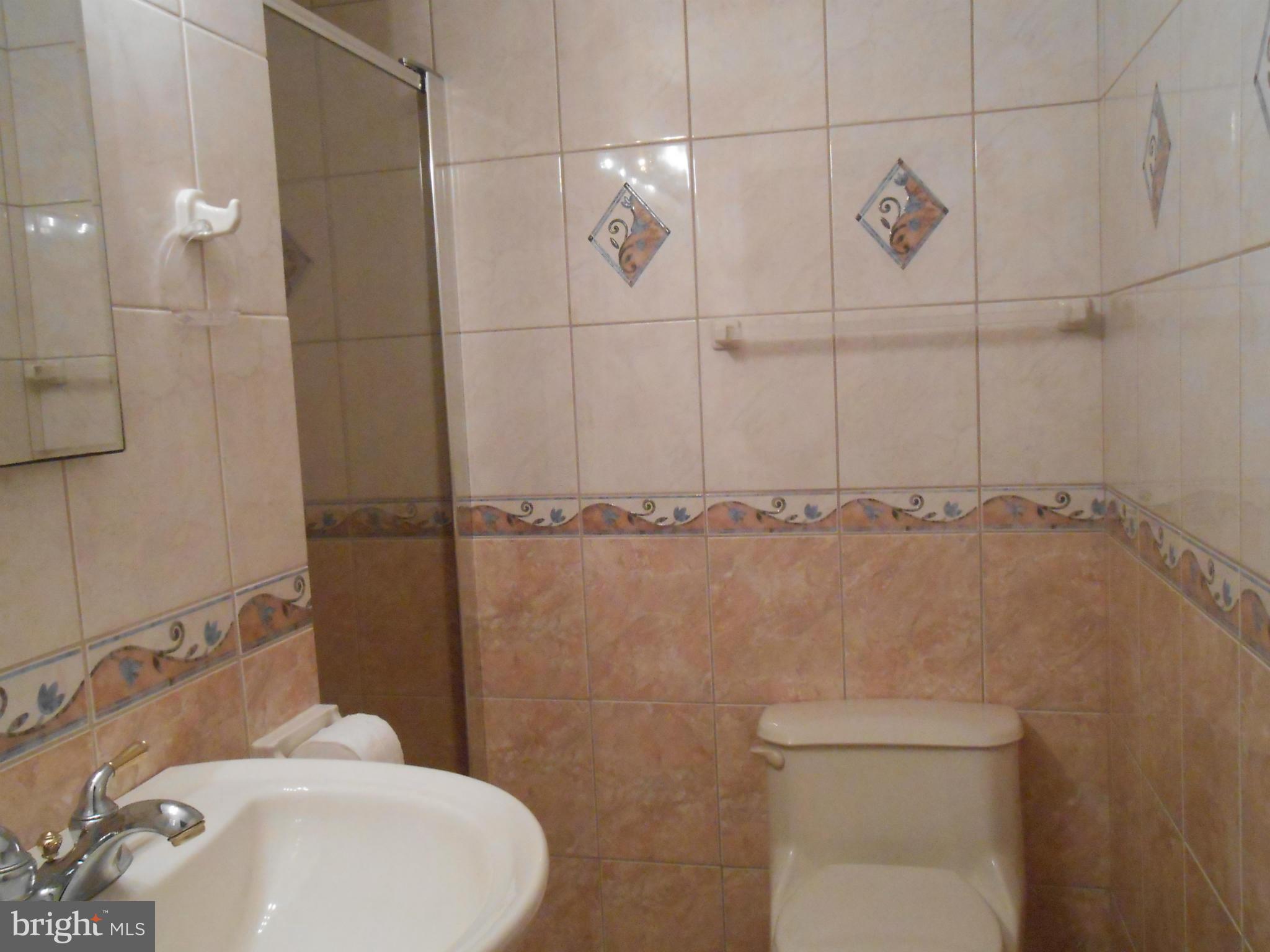 18111 Three Notch Road Lexington Park, MD 20653 - Photo 10 of 23 a bathroom with a toilet a sink and mirror