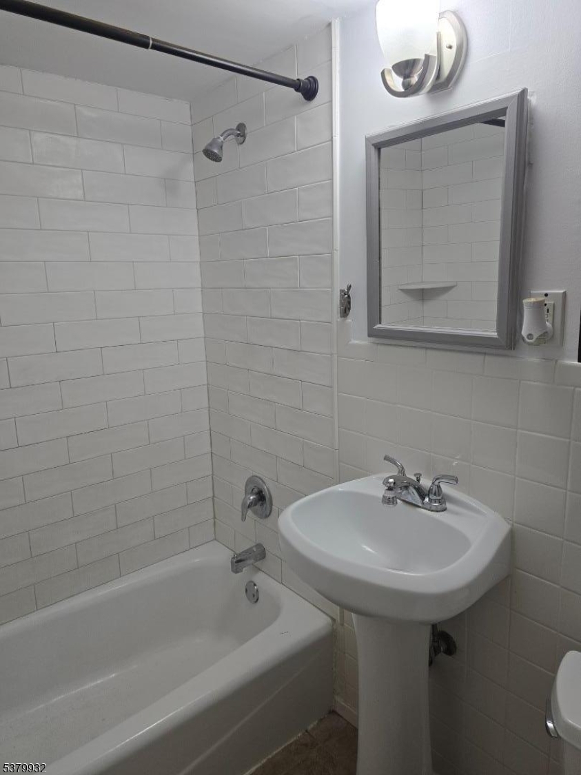 2350 Route 10 Morris Plains, Unit D14 Morris Plains, NJ 07950 - Photo 13 of 13 a bathroom with a sink a mirror and a bathtub