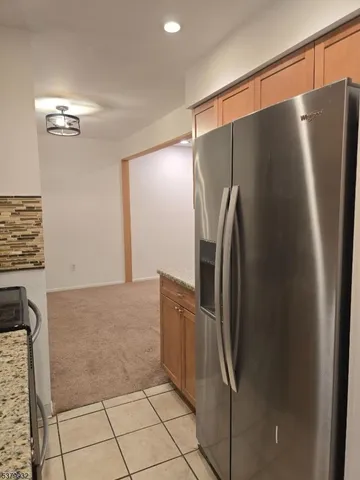 a kitchen with granite countertop a stove microwave and sink