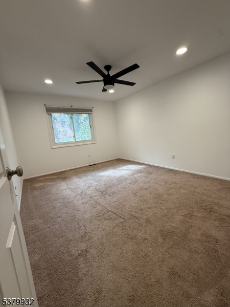 2350 Route 10 Morris Plains, Unit D14 Morris Plains, NJ 07950 - Photo 9 of 13 an empty room with windows and ceiling fan