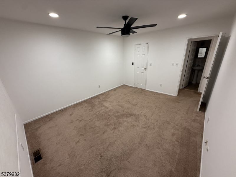 2350 Route 10 Morris Plains, Unit D14 Morris Plains, NJ 07950 - Photo 10 of 13 a view of a livingroom with a ceiling fan and wooden floor