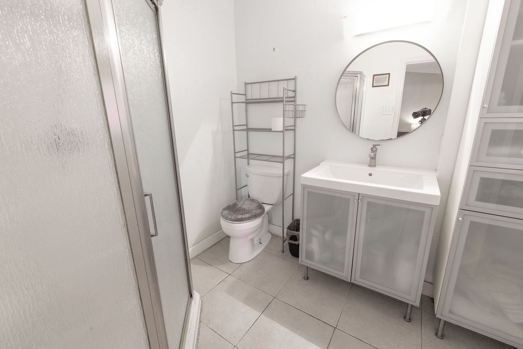 5310 Presidio Road Austin, TX 78745 - Photo 17 of 34 A well-lit primary bathroom featuring a sleek shower, modern vanity, and practical storage solutions.