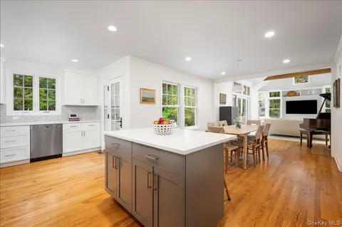 a kitchen with a sink cabinets and wooden floor