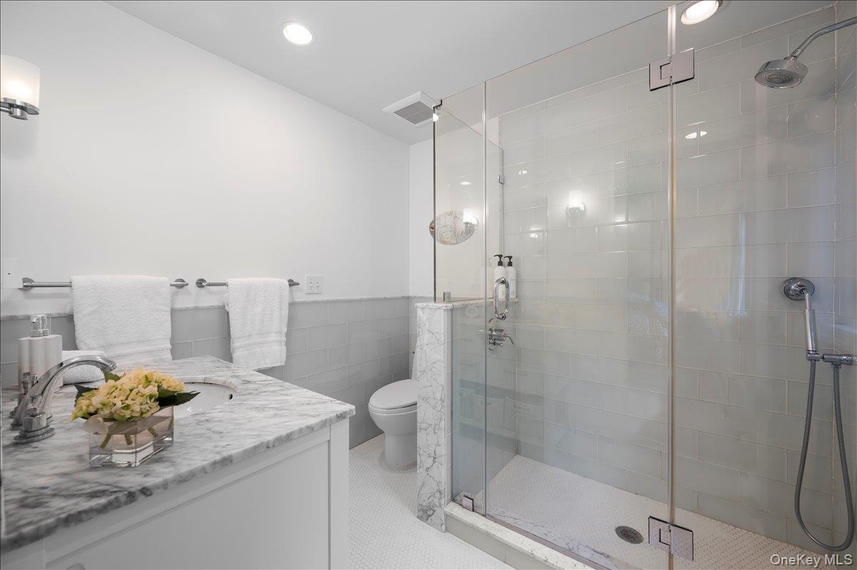33 Pryer Lane Larchmont, NY 10538 - Photo 21 of 37 a bathroom with a granite countertop sink a toilet and shower
