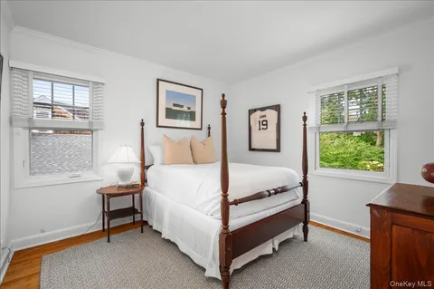 a bed sitting in a bedroom next to a window