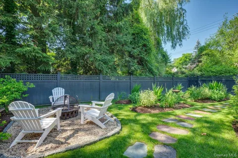 a view of a chair and table in the garden