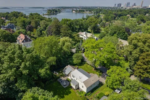 an aerial view of a house with yard swimming pool and outdoor seating
