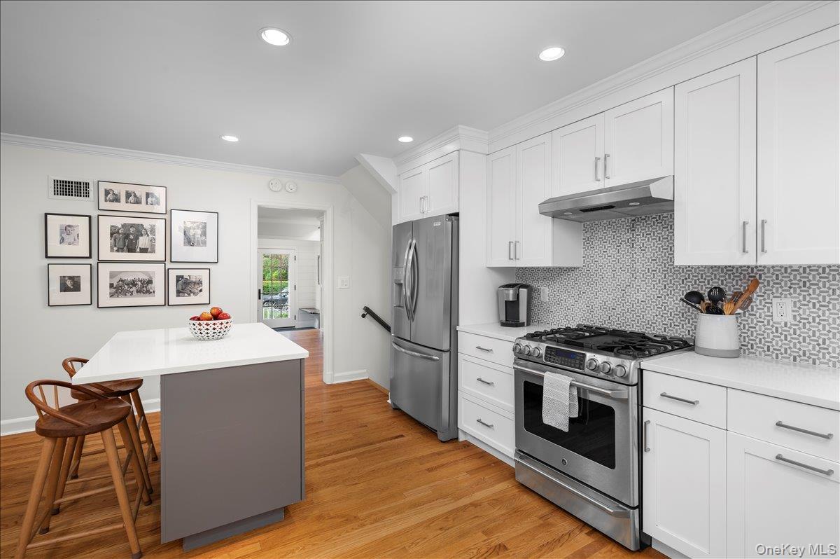 33 Pryer Lane Larchmont, NY 10538 - Photo 10 of 37 a kitchen with kitchen island a stove a sink and a refrigerator