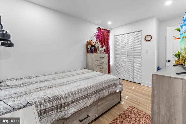 a bedroom with a bed and a dresser