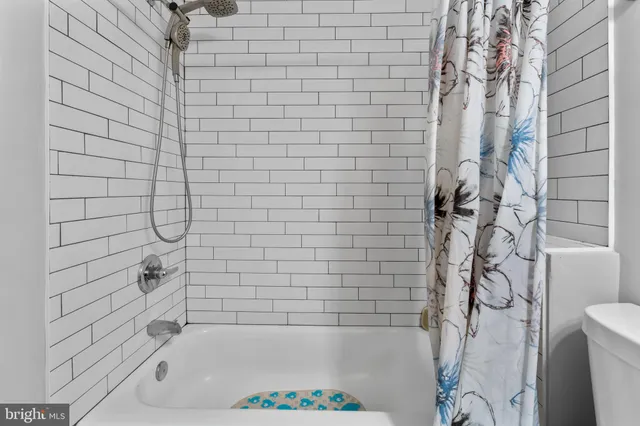 a bathroom with a bathtub and shower