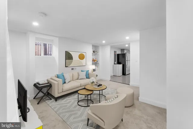 a living room with furniture and a dining table with wooden floor