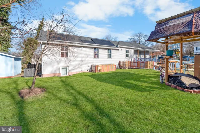 a view of a house with a yard porch and sitting area