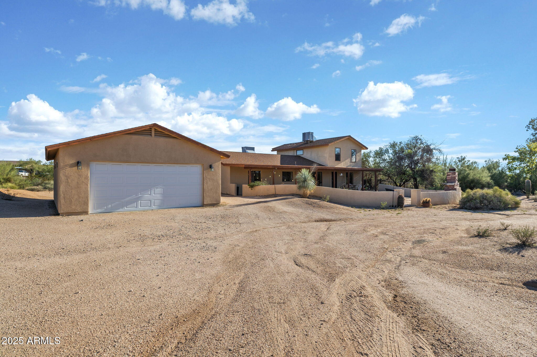 6319 East Lowden Road Cave Creek, AZ 85331 - Photo 11 of 52 a front view of a house with a yard and garage
