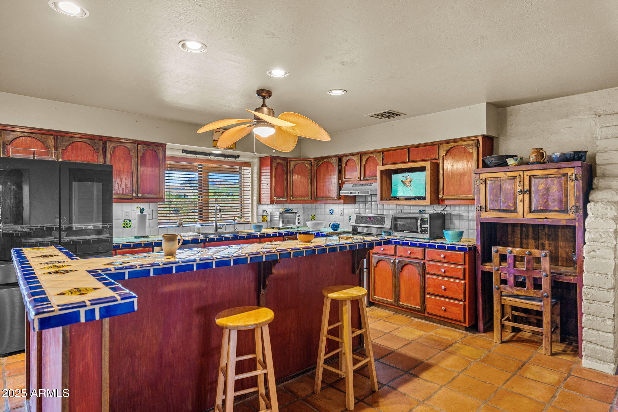 6319 East Lowden Road Cave Creek, AZ 85331 - Photo 23 of 52 a kitchen with stainless steel appliances granite countertop a stove and a dining table