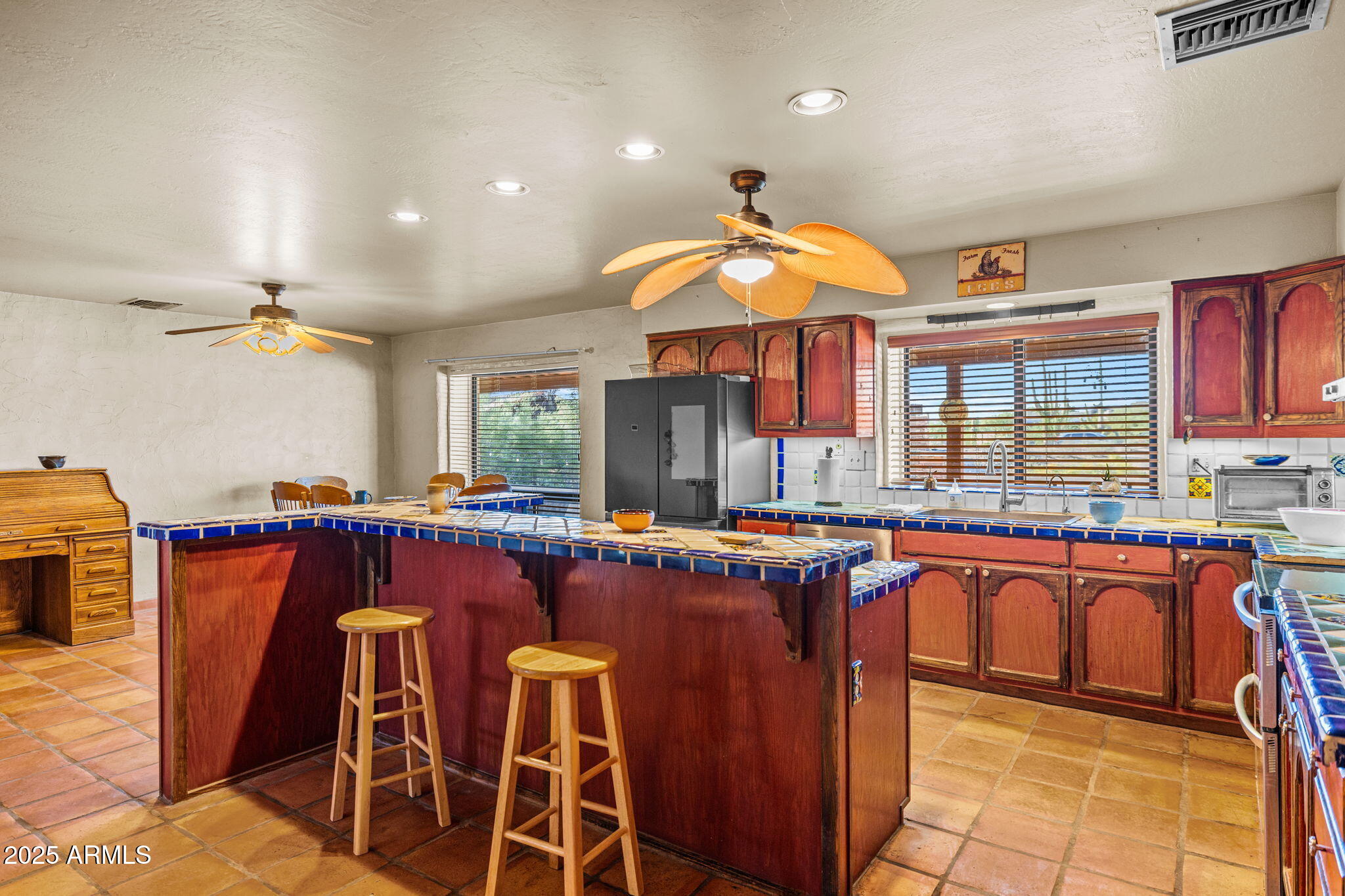 6319 East Lowden Road Cave Creek, AZ 85331 - Photo 24 of 52 a kitchen with stainless steel appliances granite countertop a sink and a refrigerator
