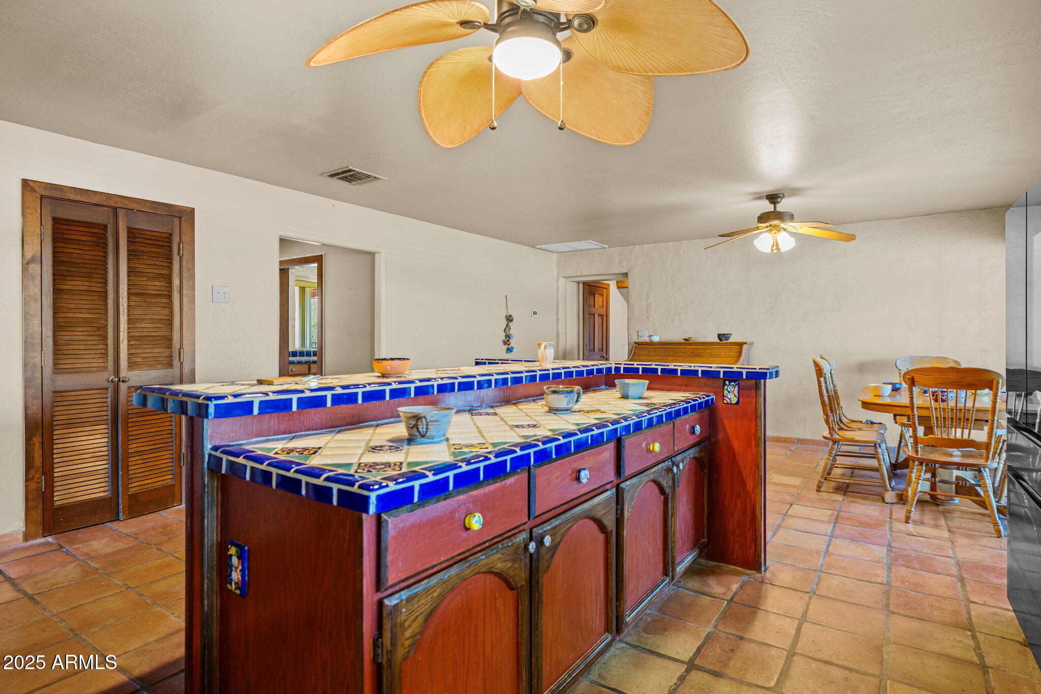 6319 East Lowden Road Cave Creek, AZ 85331 - Photo 25 of 52 a kitchen with stainless steel appliances granite countertop a stove and a dining table