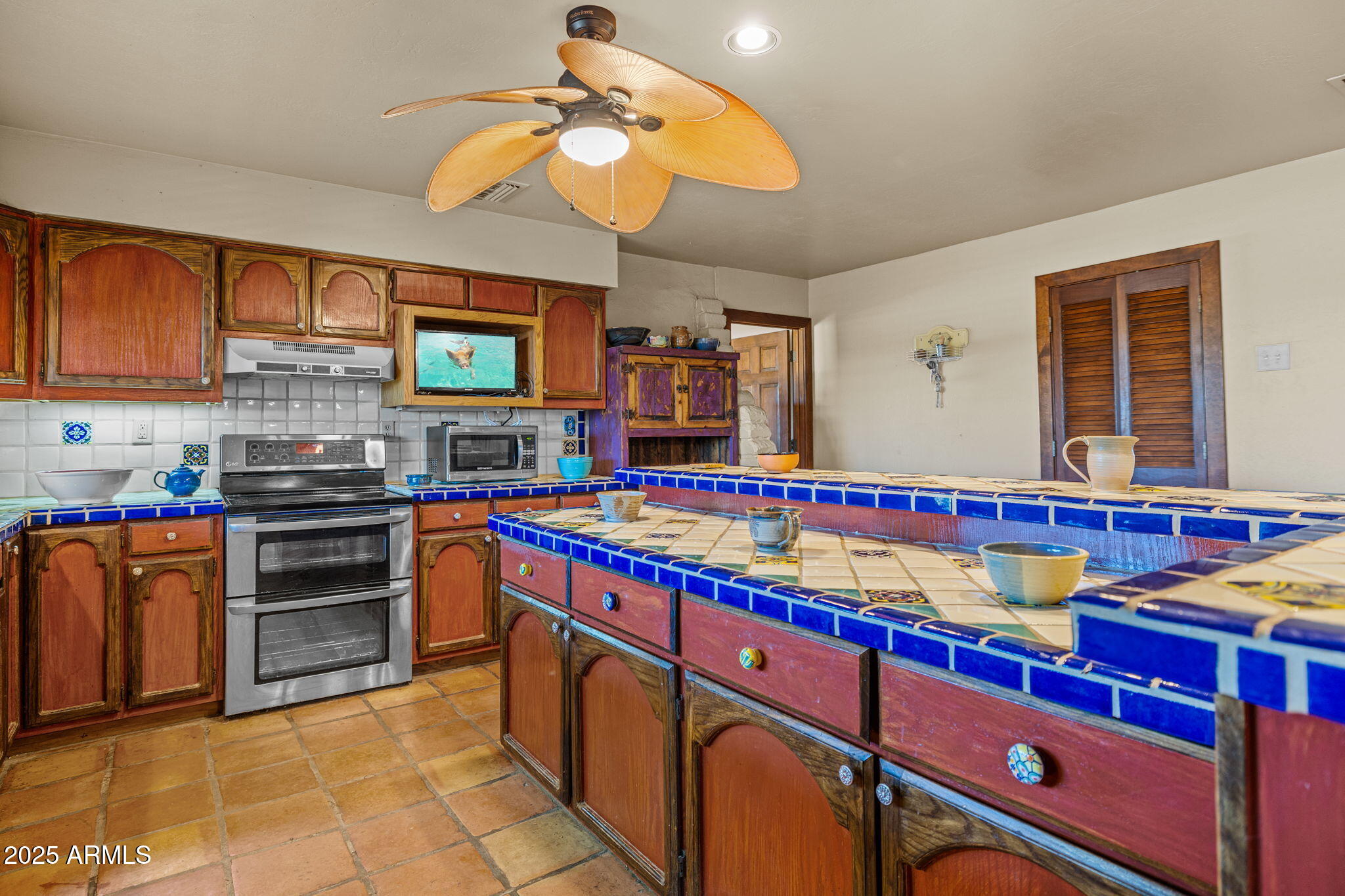 6319 East Lowden Road Cave Creek, AZ 85331 - Photo 26 of 52 a kitchen with stainless steel appliances granite countertop a stove and cabinets