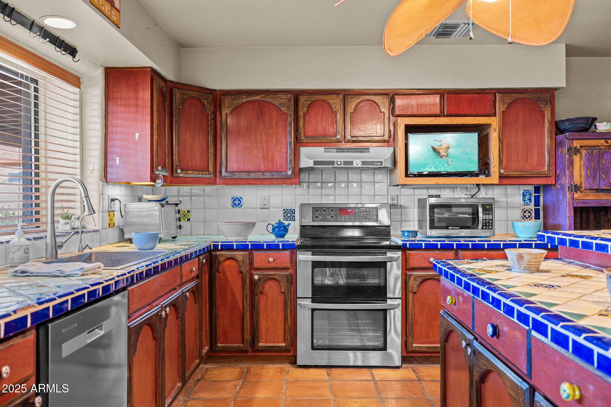 6319 East Lowden Road Cave Creek, AZ 85331 - Photo 27 of 52 a kitchen with stainless steel appliances a stove sink and cabinets