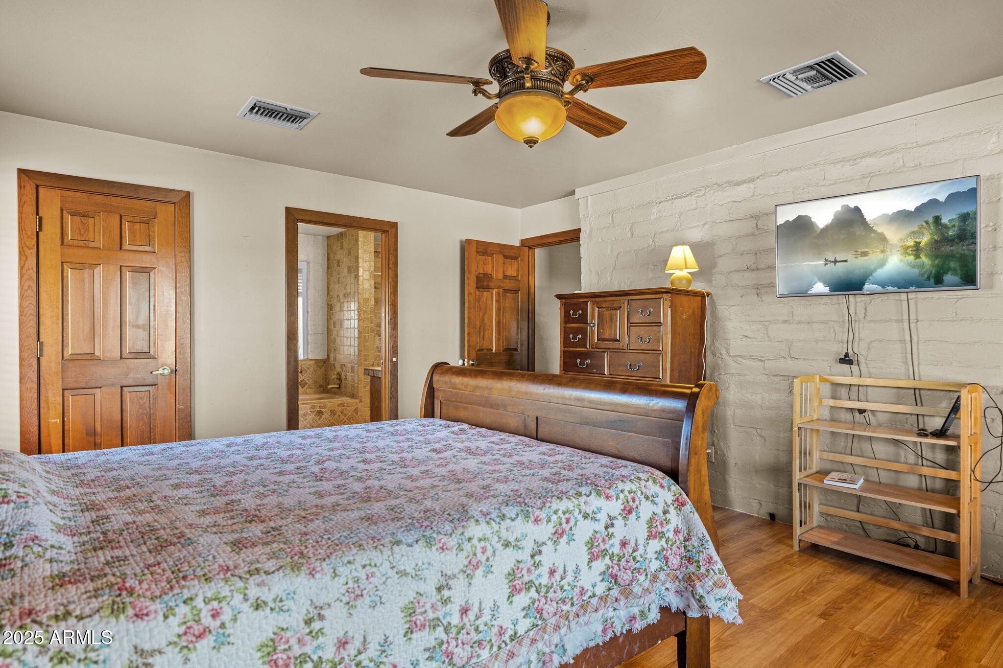6319 East Lowden Road Cave Creek, AZ 85331 - Photo 32 of 52 a bedroom with a bed and wooden floor