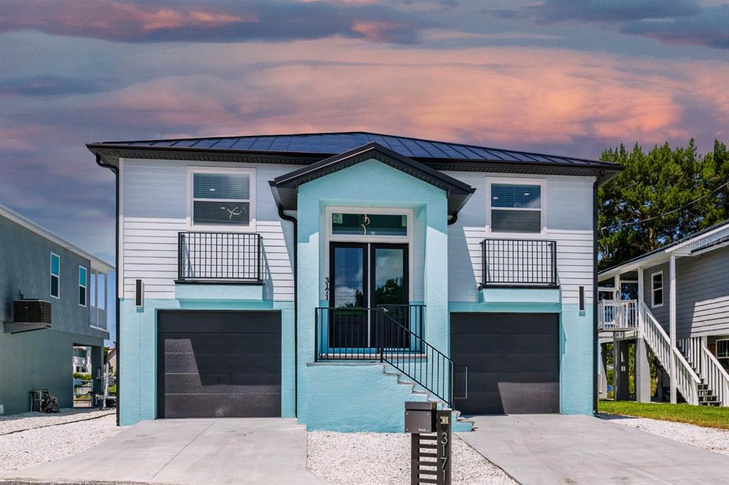 a front view of a house with garden