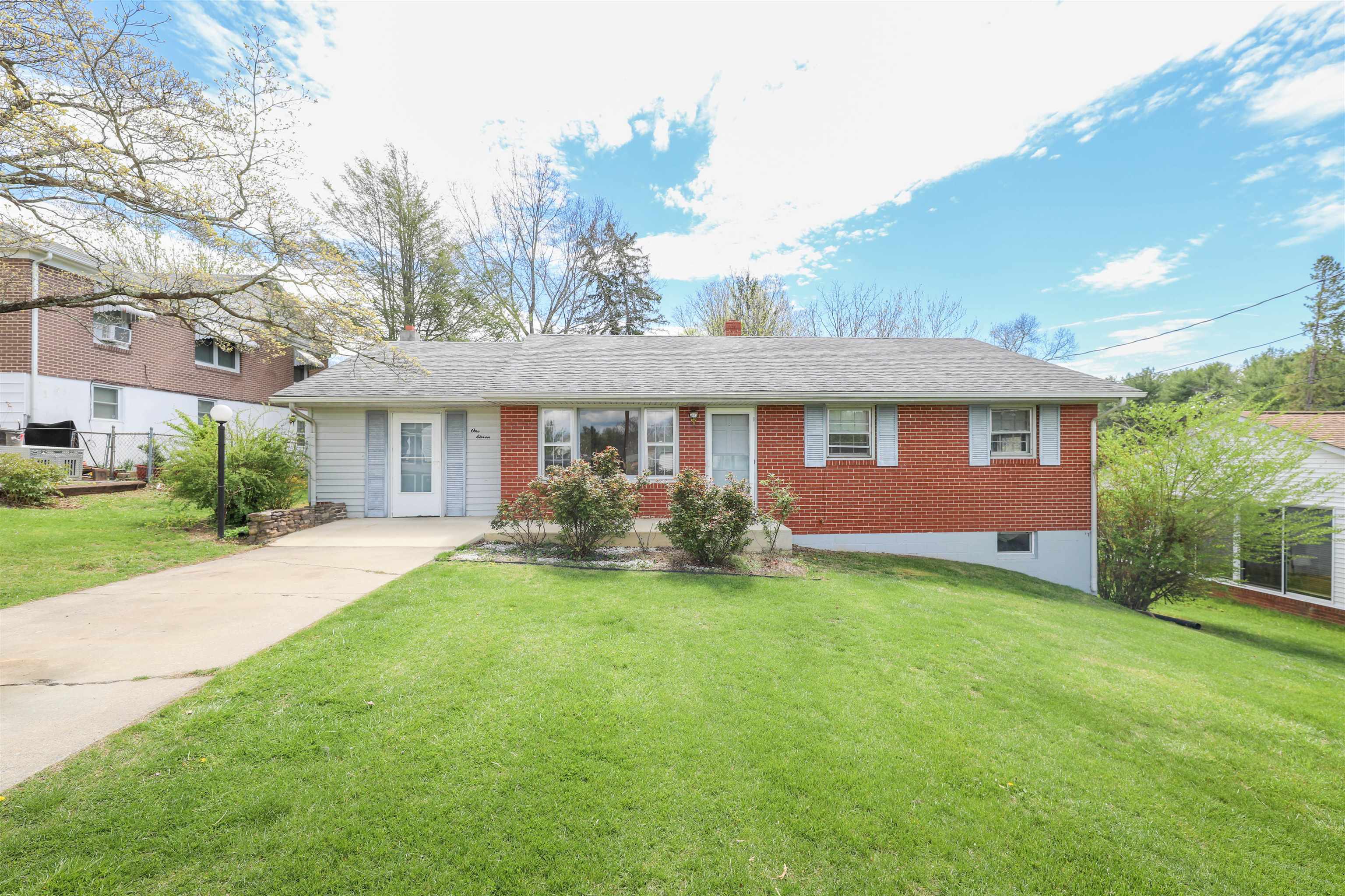 a front view of a house with yard and porch
