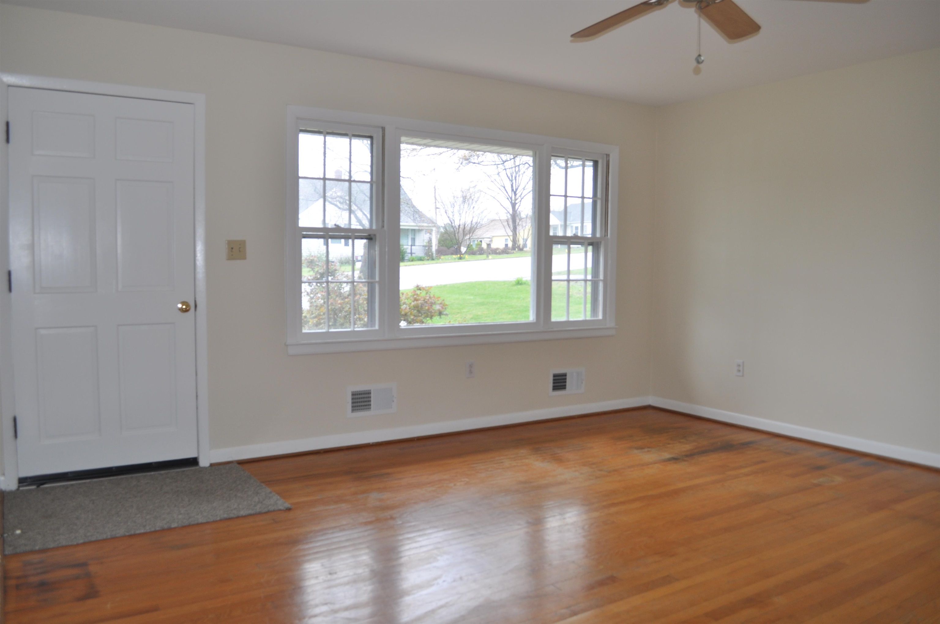 111 Devon Road Staunton, VA 24401 - Photo 12 of 28 an empty room with wooden floor and windows