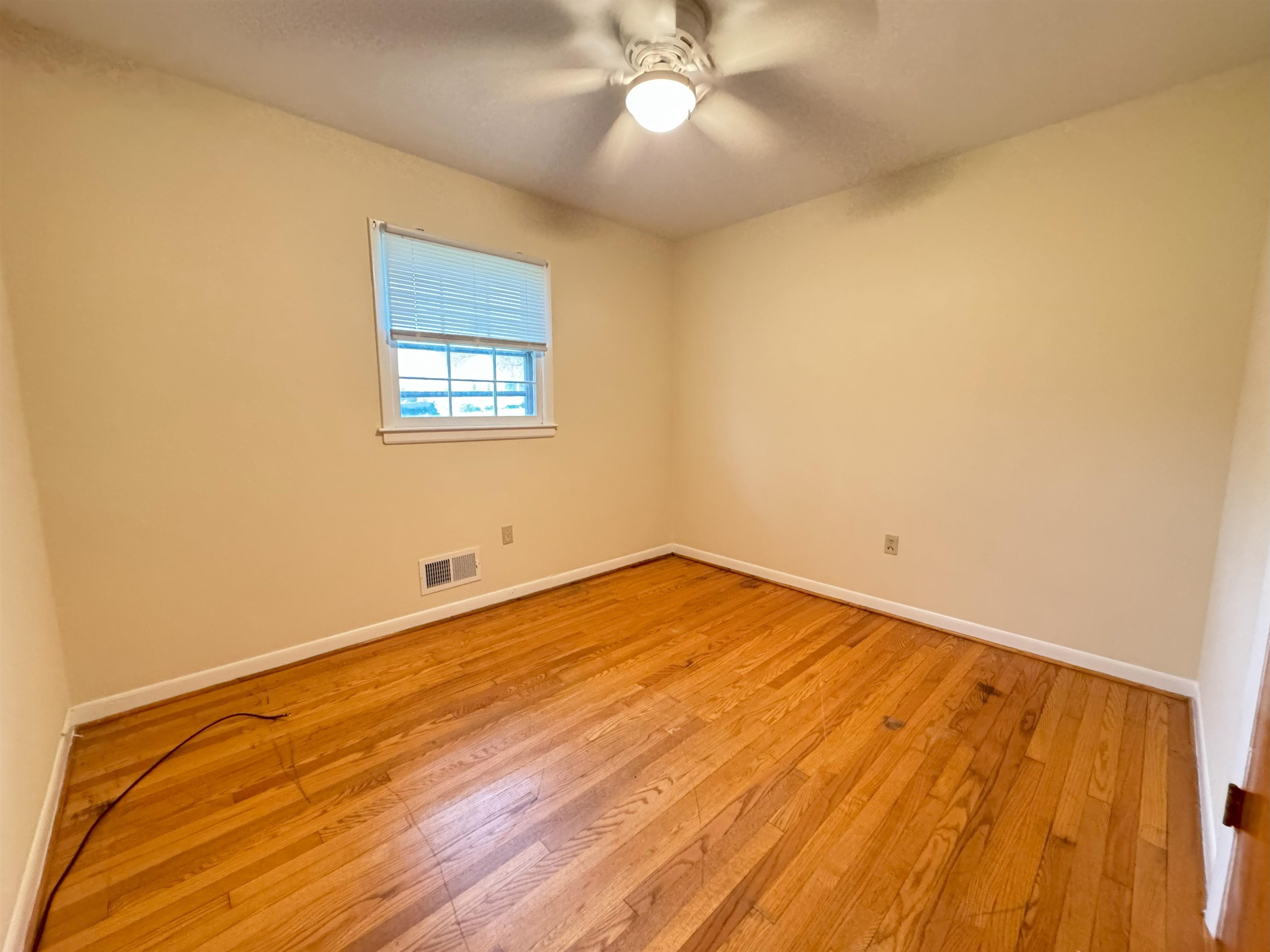 111 Devon Road Staunton, VA 24401 - Photo 25 of 28 a view of an empty room with wooden floor and a window