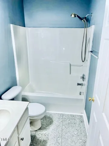 a bathroom with a toilet and a bath tub