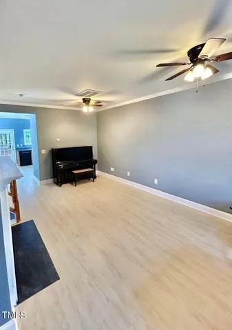 a view of empty room with furniture and a ceiling fan