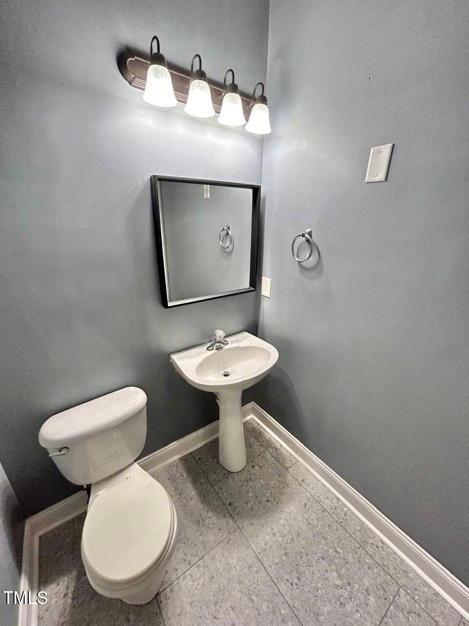 33 Sharpstone Lane Durham, NC 27703 - Photo 6 of 17 a bathroom with a toilet sink and mirror