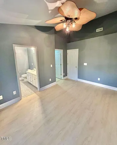 a view of a room with a ceiling fan and bathroom