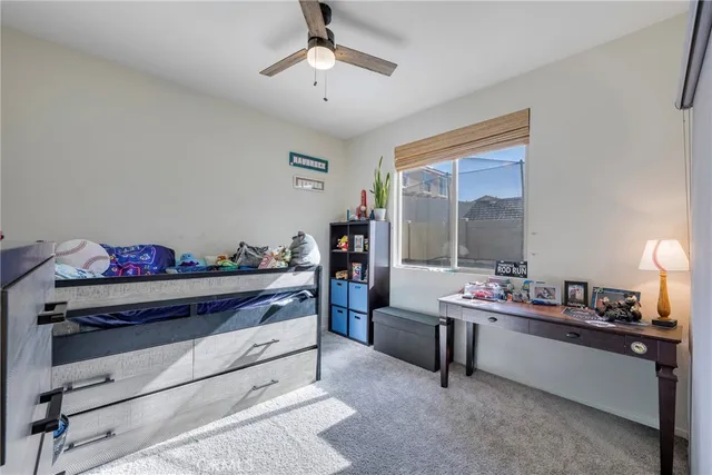 a spacious bedroom with a bed and a flat screen tv