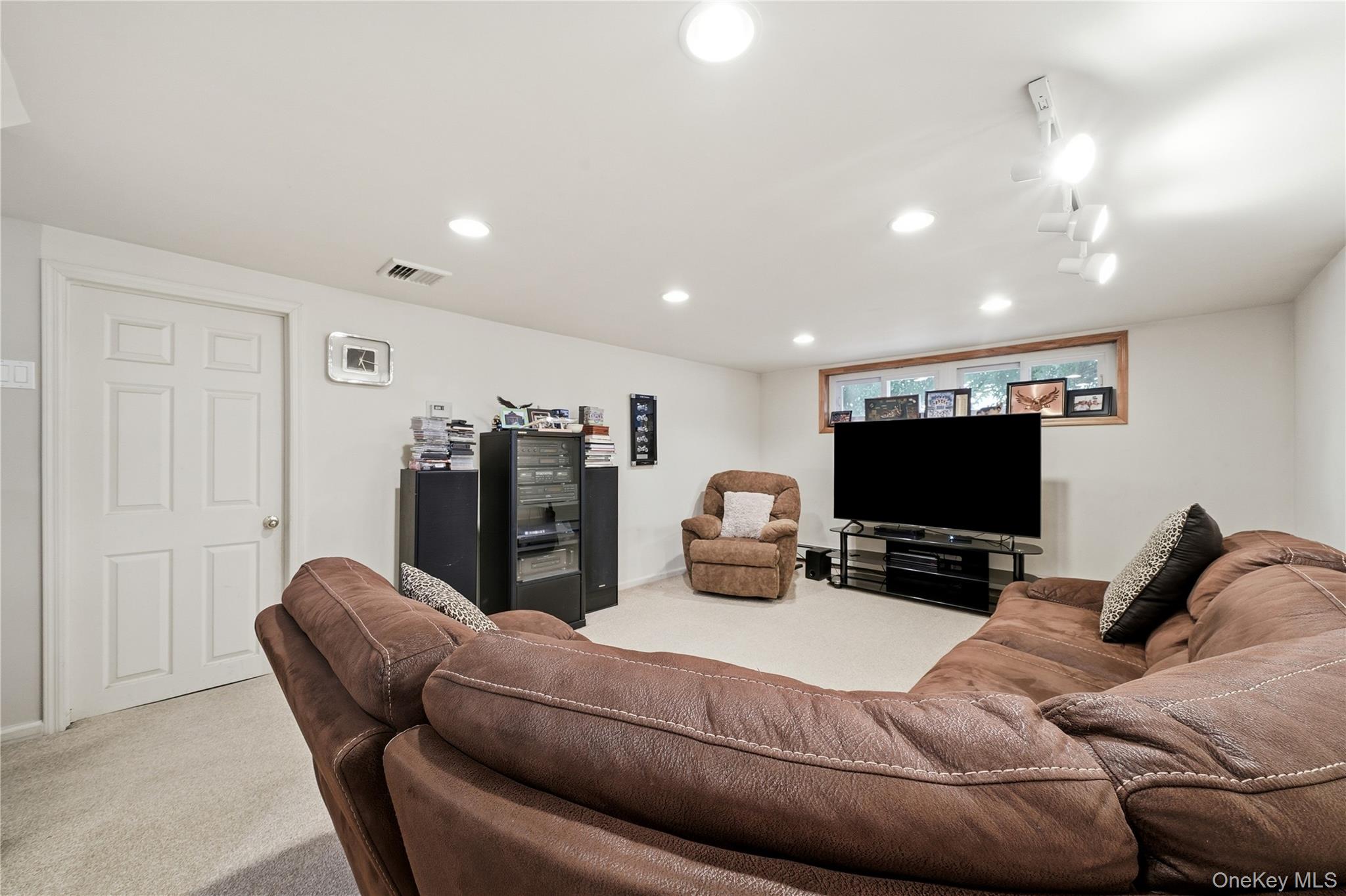 1853 Decatur Avenue Merrick, NY 11566 - Photo 31 of 43 a living room with furniture and a flat screen tv