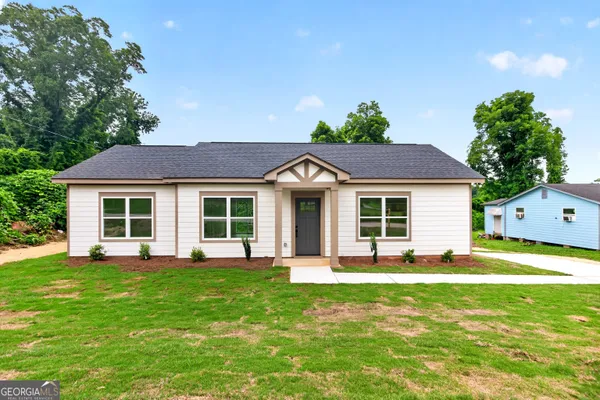 a front view of a house with a yard