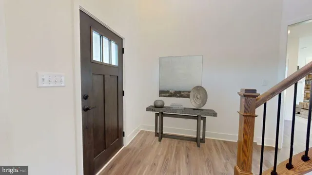 a view of entryway and hall with wooden floor