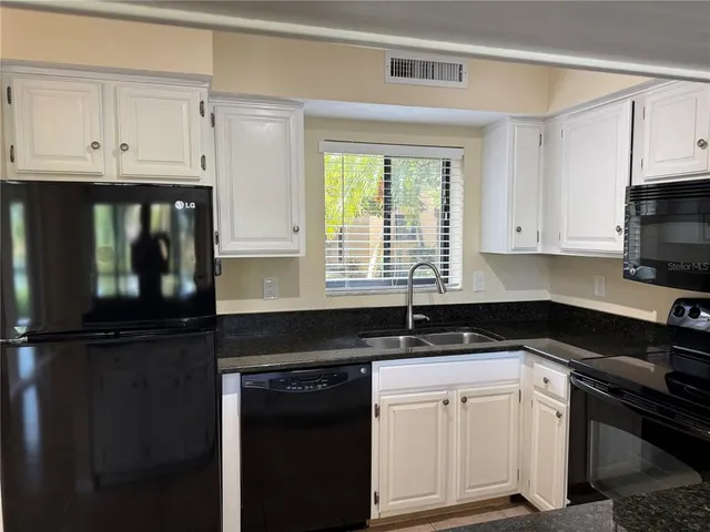 a kitchen with a refrigerator and a counter top