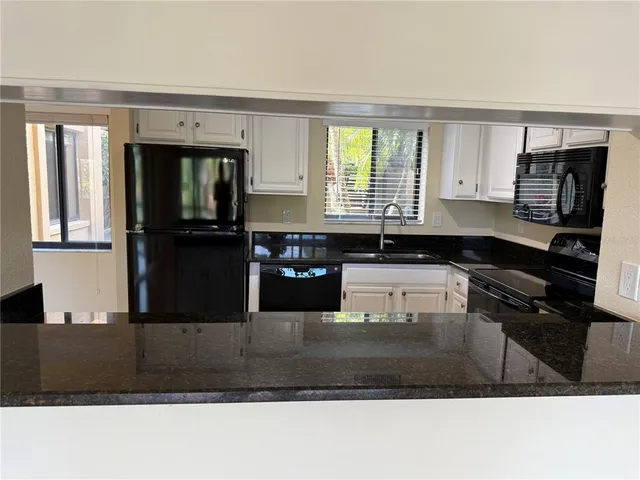 a kitchen with a refrigerator stove and sink