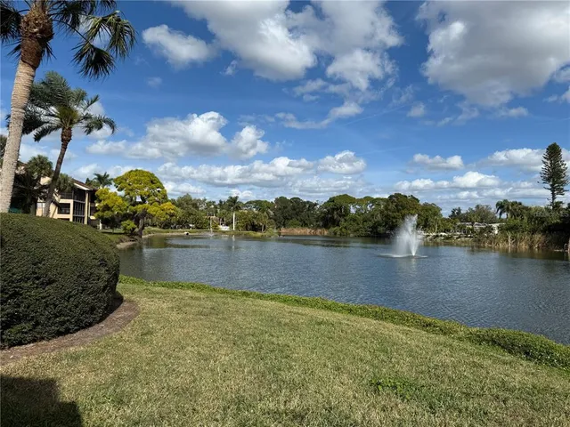 a view of a lake with houses in the back