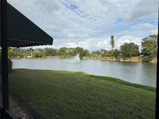 a view of a lake with houses in the back