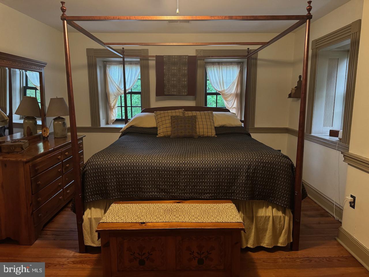 262 Orrtanna Road Orrtanna, PA 17353 - Photo 32 of 43 a bedroom with a bed and a large mirror with a wooden floor