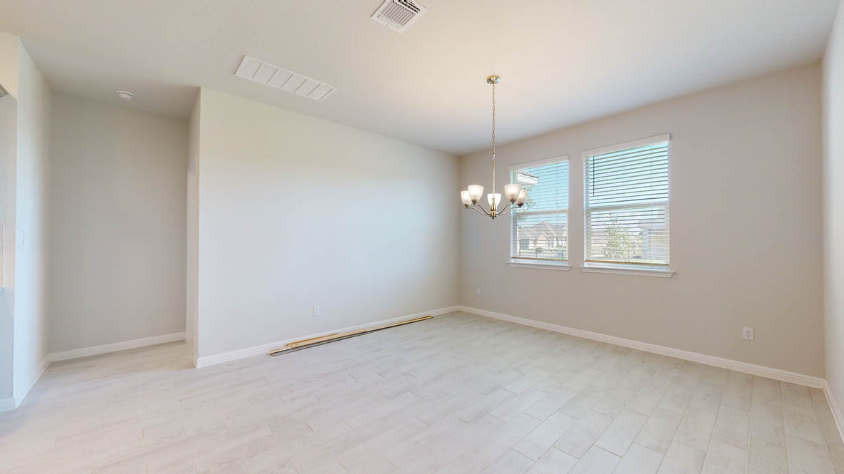 808 Gauge Road Thorndale, TX 76577 - Photo 10 of 31 Ceramic tile flooring under a traditional chandelier illuminates this inviting dining space.